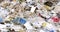 Piles of different plastic and paper garbage for sorting and recycling.