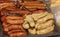 Piles of different sausages laying on a metal pan