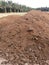 Piles of dried sandy Chicken manure on the field.