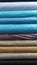 Piles of fabrics of various motifs and colors for sale