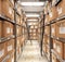 Piles of files and documents are placed on metal shelves with folders and documents in a cardboard box, archive,