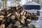 Piles of firewood on snowy ground in winter for fireplace and warmth in cabin