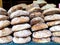 Piles of fresh baked very large rounds of bread in a Spanish open market