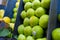 Piles of fresh and juicy-looking green apples on a fruit stand