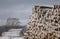 Piles of freshly cut logs under the snow, ready to be taken out of the forest