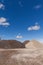 Piles of Gravel at Construction Site under Bright Blue Sky