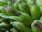 Piles of green bananas are sold in the local Indonesian market. Banana branch at the market. files 2