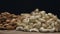 Piles of mixed nuts on a wooden table isolated on black