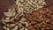 Piles of mixed nuts on a wooden table isolated on black