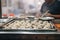 piles of plump dumplings in a steamy vendor tray