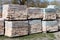 Piles of restored bricks on pallets, outdoors.Construction Materials.