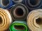 Piles of rolls of textile fabrics of various colors
