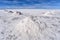 Piles of salt drying in the sun near the mining town of Colcani. Salar de Uyuni, the worlds largest salt flats, Bolivia