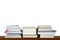 Piles or stack of books for reading and study on wooden shelf on white blank wall background