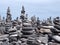 Piles of tall stacked grey pebbles on beach