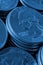 Piles of US American coins of 25 cents quarters close-up. Dark blue vertical background for news about USA money, economy,