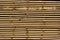 Piles of wooden boards in the sawmill, planking. Warehouse for sawing boards on a sawmill outdoors. Wood timber stack of