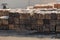 Piles of wooden planks at the seaport berth. Warehouse for sawing in stacks for loading in the open air. Material wooden wooden b