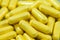 Piles of yellow capsules macro