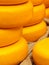 Piles of yellow Dutch cheese on a market