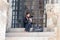 The Pilgrim sits on the steps of the Church of the Holy Sepulchre in the old city of Jerusalem, Israel.