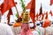 Pilgrimage - a woman carrying a holy basil plant pot over her head