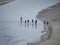 Pilgrims crossing the tidal bay at Mont Saint Michel, France