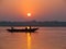 Pilgrims floating by boat of the sacred Ganges river. Sunrise in Varanasi, Uttar Pradesh, India.