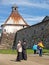 Pilgrims stand near a tower of the Solovki monastery