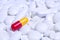 Pill capsule on white tablets background