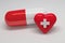 Pill with red heart and white cross