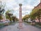 A pillar with the coat of arms of the tsarist Russian Empire at the top and the modern coat of arms of the city at the bottom in