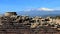 Pillar and old wall with view of Etna volcano