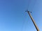 A pillar of power lines against a blue sky. Power Wires