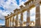 Pillars of Parthenon in Athens being reconstructed with old and new marble against a beautiful sky and machinery visible in backgr