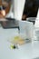 Pillbox with vitamins on the desk, glass of water and computer