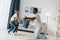 Pillow fight. African american father with his young son at home