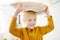 Pillow fight. Mischievous preschooler child jumping on a sofa and hitting with pillows.Active games for child at home