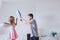 Pillow fight, young happy family couple having fun at home