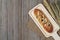 Pillow raisin bread and wheat ears and sack on wooden background,top view