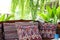 pillow on wooden settee bench on terrace patio near garden