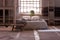 Pillows and blanket on bed in japanese bedroom interior with stool and plant at window