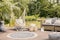 Pillows on hammock on terrace with round rug and rattan sofa in