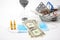 Pills, ampoules and syringe for injection, medical mask, money and hourglass on a white background. business and medicine