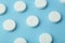 Pills background. Pills, drags and medecine concept. White tablets on a blue background