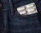 Pills blister pack of white capsules in jeans pocket