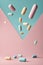 Pills and Capsules Floating on Pastel Background