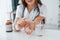 Pills and glass of water. Professional medical worker in white coat is in the office