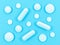 Pills isolated on blue background. Pharmacy theme. Pharmaceutical tablets.