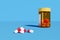 Pills red an white next of pill bottle isolated on blue background. Selective focus. 3d illustration